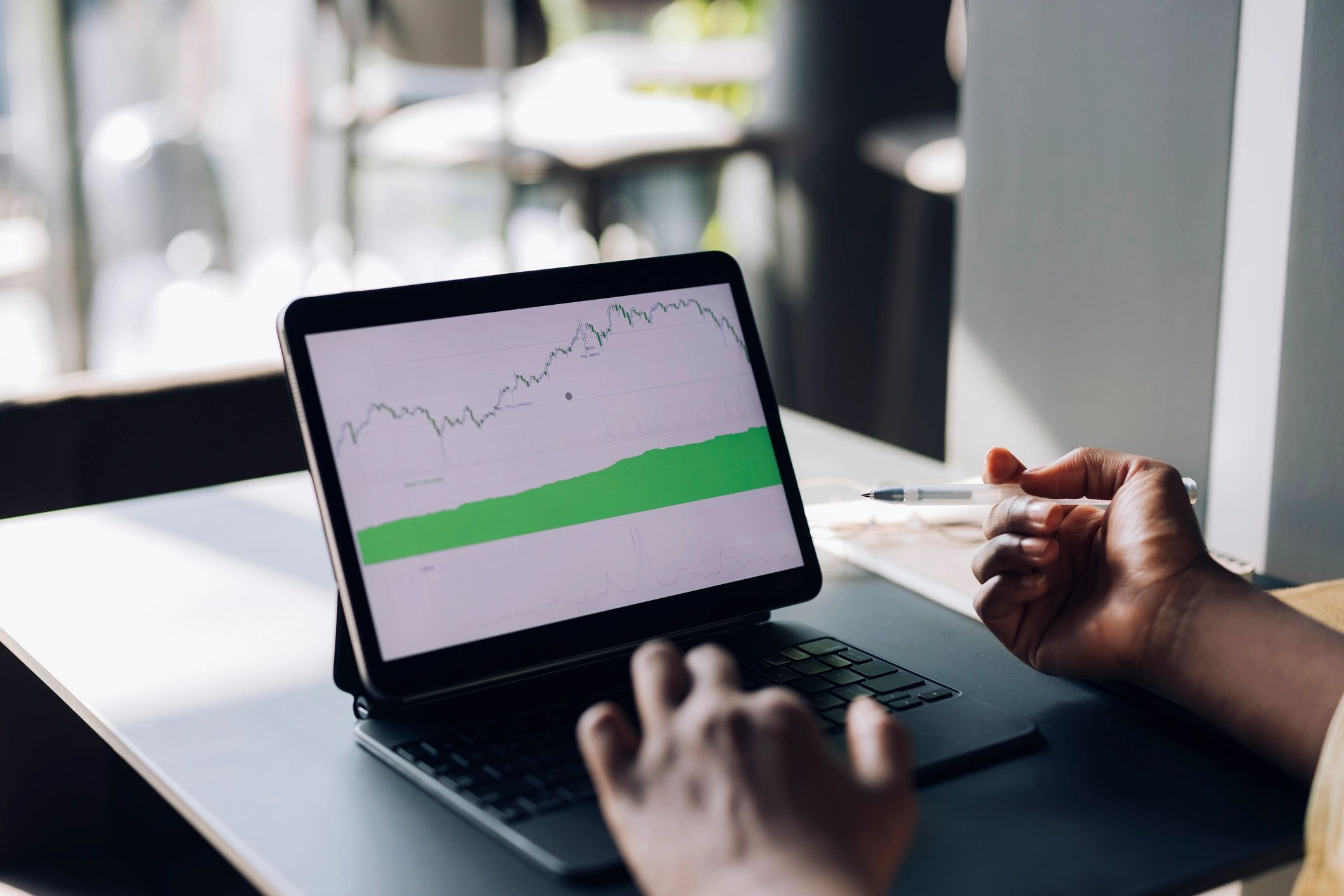 Business professional analyzing investment data on a tablet