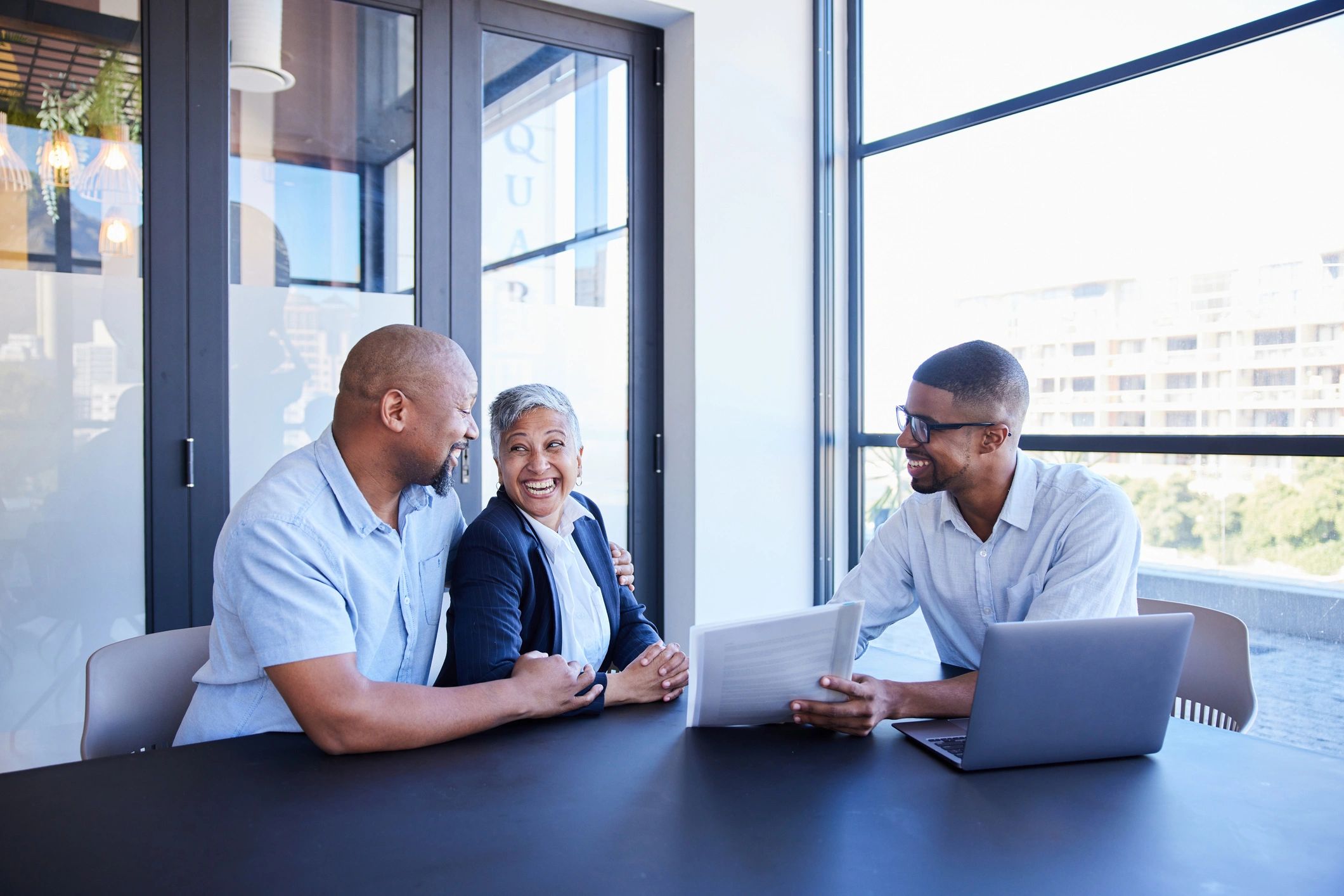 Mature couple reviewing financial documents with an advisor