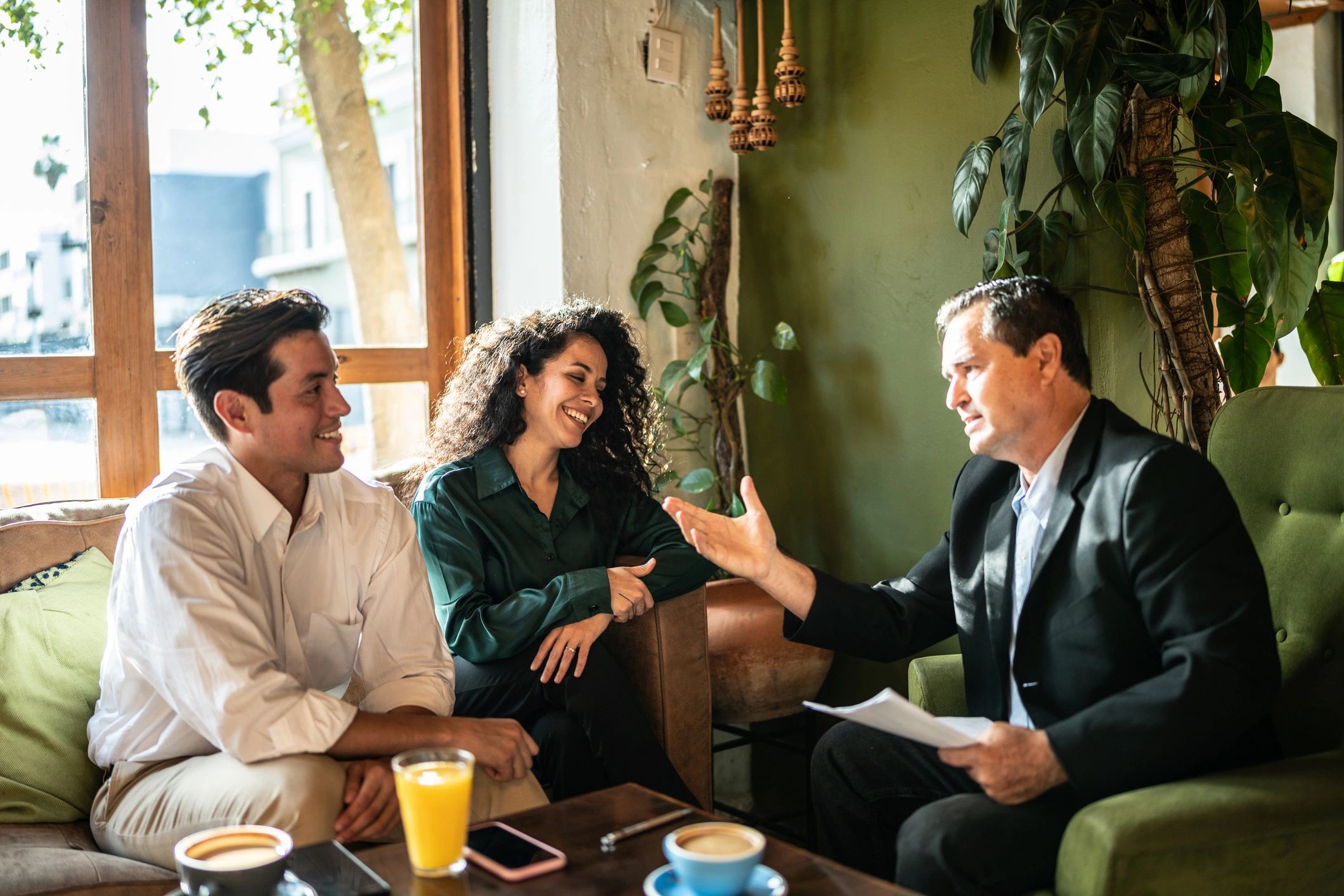 Couple meeting with a financial advisor at a coffee shop